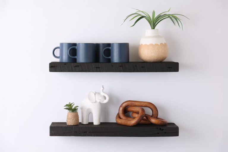 Charred wood floating shelves styled with ceramic mugs, decor, and plants—handcrafted display shelves by Legacy Handcraft, showcasing modern rustic design and artisan craftsmanship